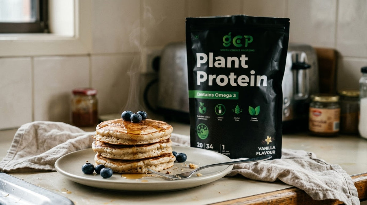 Stack of homemade fluffy protein pancakes with blueberries and maple syrup beside a Green Choice Proteins Vanilla pouch in a home kitchen