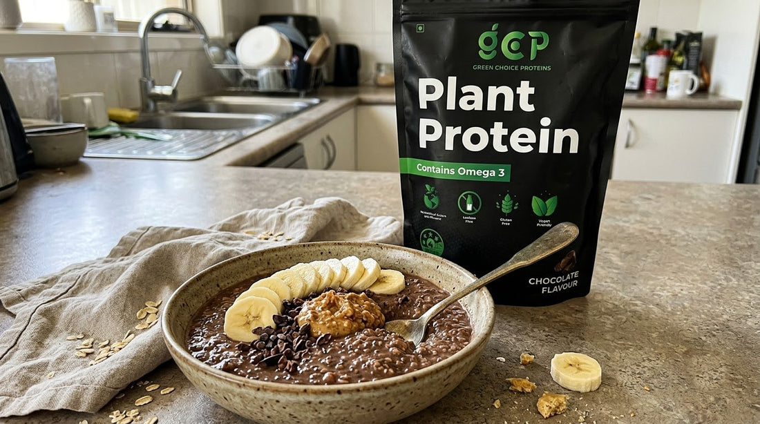 Bowl of chocolate protein overnight Weet-Bix topped with banana, peanut butter and cacao nibs beside a Green Choice Proteins Chocolate pouch in a home kitchen