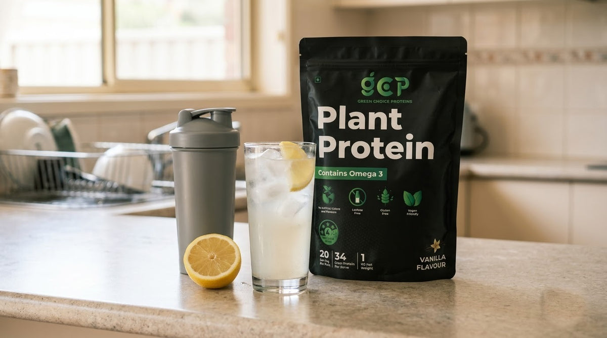 Glass of icy plant protein drink with a lemon slice next to a shaker and a Green Choice Proteins Vanilla pouch